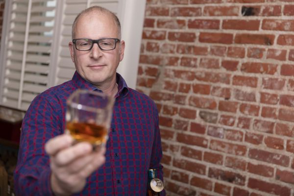 Scott Harris inspects a glass of whisky